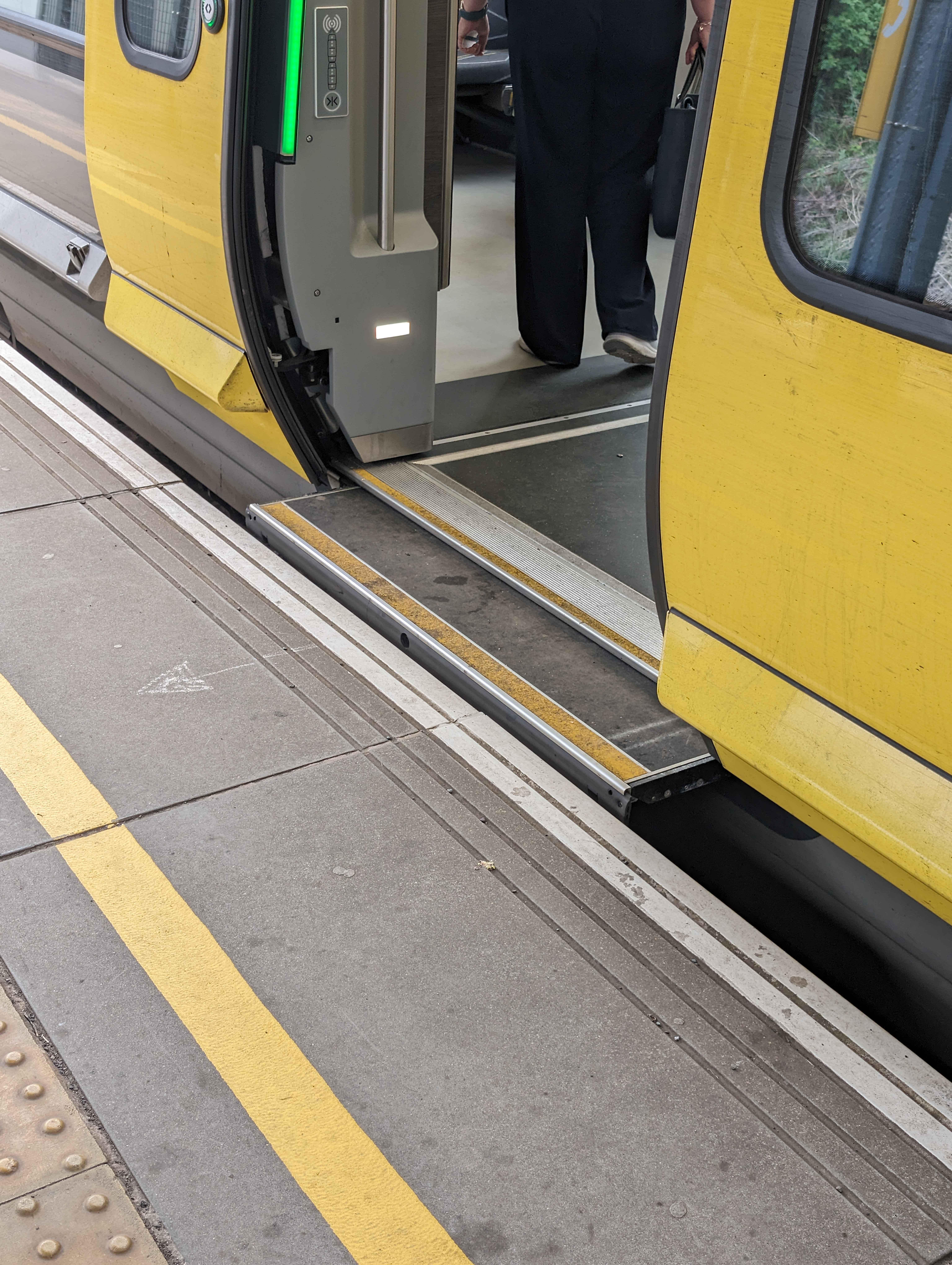 A photograph of the open doors of a Class 777 METRO train. A pop out surface fills the gap between the train and the platform and the floor is at the same height as the platform.